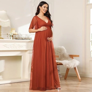Detail of elegant V-neck maternity tulle gown with butterfly sleeves in terracotta red