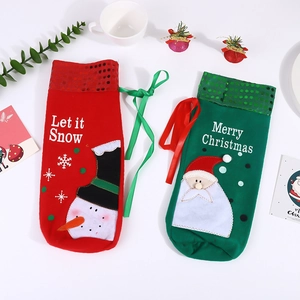 Detailed view of sequined Christmas wine bottle covers with Santa and Snowman embroidery