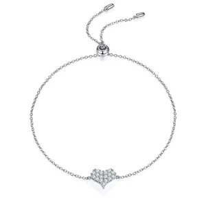 Detailed macro view of an 18K gold heart-shaped adjustable bracelet with sparkling zircons