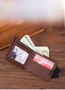 Detailed interior of brown leather bifold wallet showing card slots and money compartments