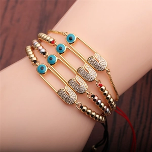 Bohemian gold four-piece bracelet set with blue evil eye and zircon safety pin charms