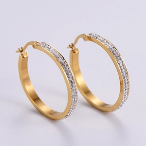 Detailed view of gold hoop earrings with double row inlaid rhinestones and pin closure