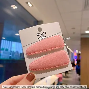 Set of two pink knit drop-shaped BB hair clips for children on display card
