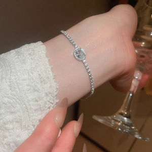 Close-up of elegant silver zircon bracelet on wrist with sophisticated evening style