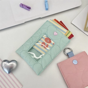 Detail of quilted card holders in mint green and pink with metallic heart accents