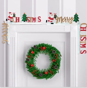 Detail of wooden Christmas door corner decor with Santa Claus and Merry letters