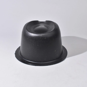 Macro side view of matte black PVC plastic cap support showing durable round base structure