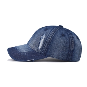 Vintage washed dark blue denim baseball cap with distressed rip details and street style