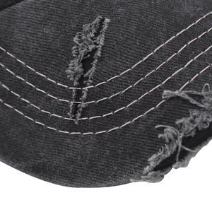 Macro detail of washed cotton baseball cap with distressed edge and triple row stitching