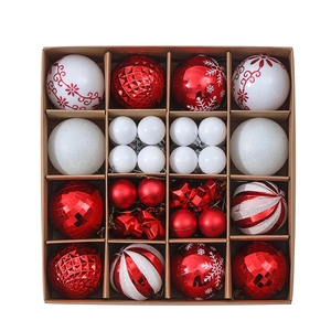 Macro detail of red and white Christmas ball ornaments with snowflake patterns in a box