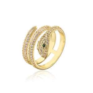 Golden snake-shaped ring with sparkling white crystals and green gemstone eyes on white background