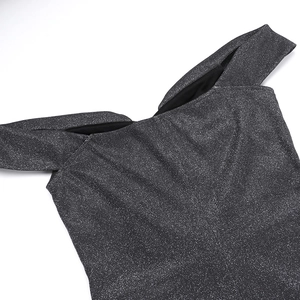 Detail of the off-shoulder neckline with shimmering silver glitter fabric on the black gown