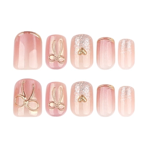 Short square cat eye press-on nails with 3D gold bows and pink pearl finish