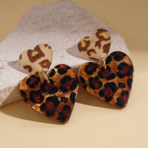 Retro acrylic leopard print double heart drop earrings on a decorative stone base