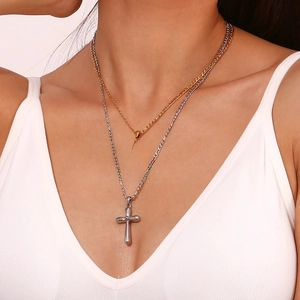 Double-layered 18K gold and silver plated stainless steel cross necklace on model