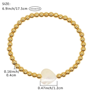 Beaded gold bracelet with white heart pendant and dimensions 17.5cm shown on white background