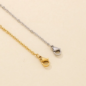 Detail shot of gold and silver metal cross chains with lobster clasps for necklaces