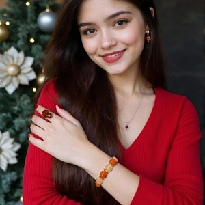 Amber jewelry set with necklace, ring and earrings shown against a festive holiday tree