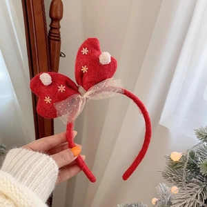 Close-up of red felt Christmas headband with embroidered heart and mesh bow detail