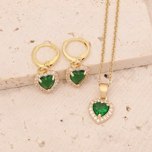 Elegant gold jewelry set with green heart pendants and sparkling zircon accents