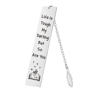 Macro view of silver stainless steel bookmark with feather charm and engraved quote