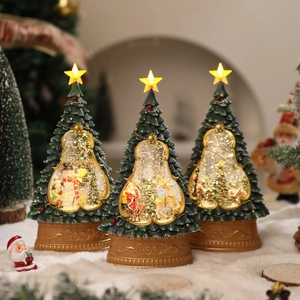 Three glowing Christmas tree water globes with Santa, snowman and deer scenes