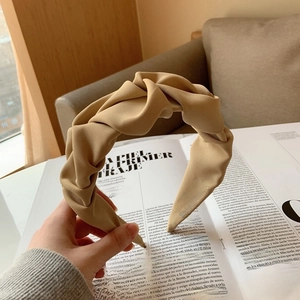 Détail de la texture textile faite à la main et de l'étiquette tissée du serre-tête plissé
