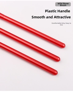 Close-up of the smooth pearlescent red handles on professional wild eyebrow brushes