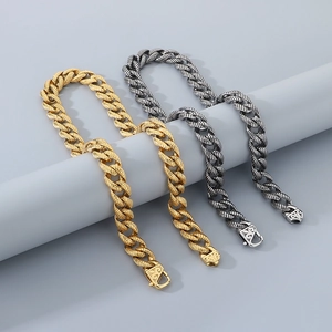 Macro detail of gold and silver twisted stainless steel bracelets with engraved clasps