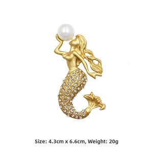 Detailed view of mermaid brooch in gold alloy with white pearls and rhinestones