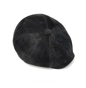Top view of a black octagonal newsboy hat with textured suede panels and a top button