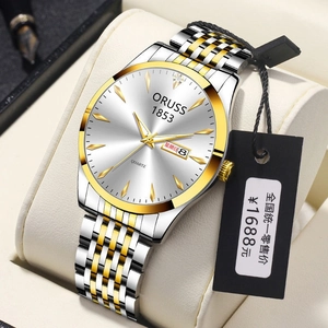 Detailed macro of the silver and gold quartz watch dial with calendar and date window