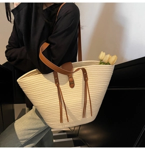 Detail of woven tote bag with cotton rope texture and caramel brown strap