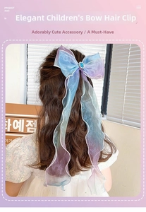 Detailed back view of a girl wearing a blue-purple gradient bow hair clip with long ribbons