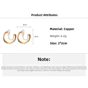 Detail view of cross spiral gold ear clips with dimensions and copper material specs