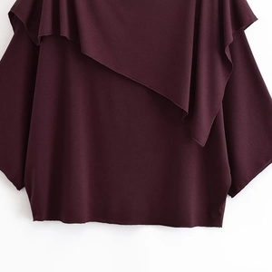 Detail of the layered maroon ruffles on the round neckline of this loose casual top