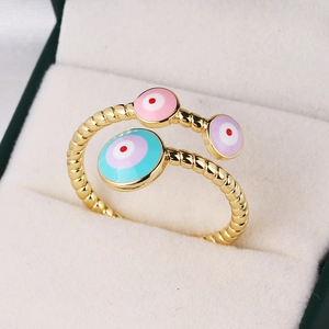 Gold-plated adjustable ring featuring three colorful enamel evil eye charms on velvet