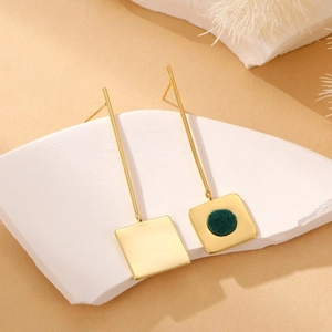 Detail of vintage geometric square drop earrings with gold finish and green flocking inlay