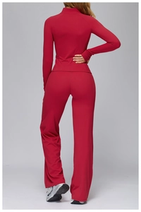 Rear view of deep red two-piece yoga set with long sleeve zip top and wide leg pants