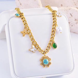 Detailed close-up of Bohemian gold chunky chain necklace with turquoise and pearl pendants