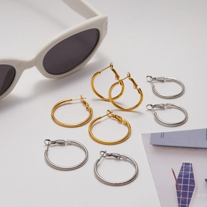 Close-up of assorted gold and silver stainless steel hoop earrings in a multi-pack set