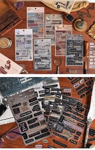 Detail of vintage English phrase PET stickers on wood with retro stationery props
