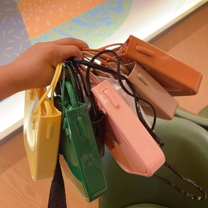 Detailed view of colorful PVC jelly handbags held together in multiple candy colors
