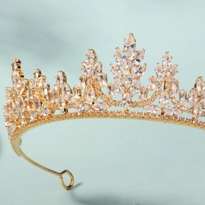 Detail of a luxury gold bridal crown with shimmering leaves made of zircon crystals