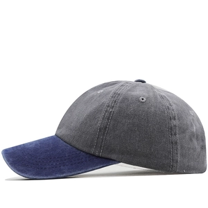 Detail of washed cotton baseball cap showing dual-tone grey and blue vintage texture