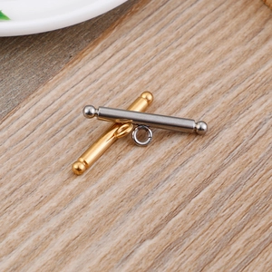 Golden and silver stainless steel OT toggle clasps for DIY necklace making on wood background