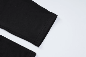 Close-up of the stitching details on cuffs and hem of the black high-elastic yoga set