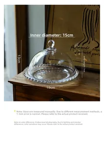 Detail view of a vintage glass snack plate with dome lid showing 19cm diameter and 13cm height