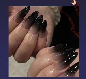 Detail of 3D Halloween press-on nails with black gradient design and pointed almond shape
