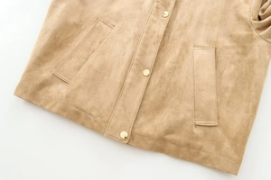 Detail of khaki faux suede biker jacket featuring gold snap buttons and slanted side pockets